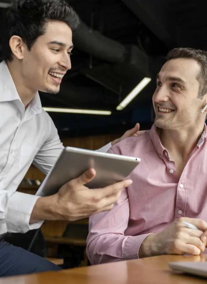 Smiley male coworkers conversing work